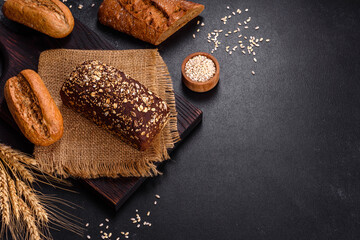 Fresh Bread on black background, top view, copy space