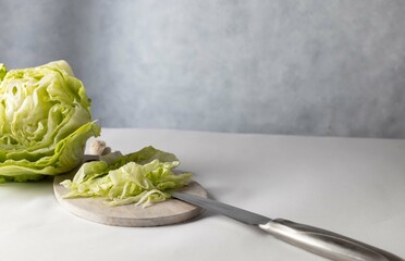 Iceberg lettuce one fresh cabbage head with a lot of green salad leaves on white background