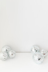Disco mirror glass ball on a white background. Trendy minimalistic decor on a white background.