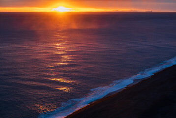Picturesque autumn evening view to endless ocean  black volcanic sand beach from Dyrholaey Cape, Vik, South Iceland. Vestmannaeyjar islands weird silhouettes on horizont.