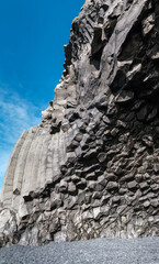 Fototapeta na wymiar Basalt rock pillars columns at Reynisfjara beach near Vik, South Iceland. Unique geological volcanic formations. Сave at the foot of the Reynisfjall mount. High resolution stitch image.