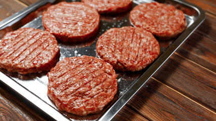Six sausages are fried by the cook of the restaurant.