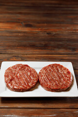 Two juicy sausages is looking at the camera.