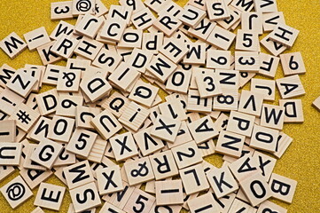 A stack of letters. loosely scattered on a table.