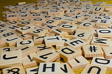 Wooden blocks with letter symbols laid out on a glowing surface.