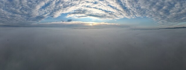Between the clouds- hills getting from inversion layer on the ground and other layer of high...