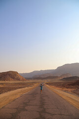 girl walking in desert road