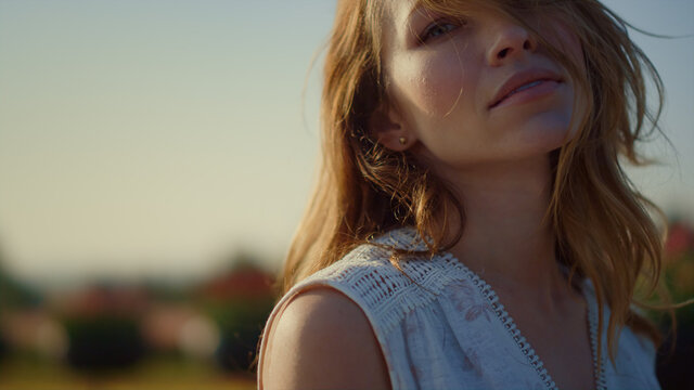 Relaxed Woman Looking At Camera With Passion Outside. Closeup Young Female Face.