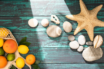 Beautiful summer holiday, fruits , orange, palm leaves on a shabby blue wooden background. The concept of summer and relaxation at sea, eco products ,holidays with family in a pleasant seaside resort.