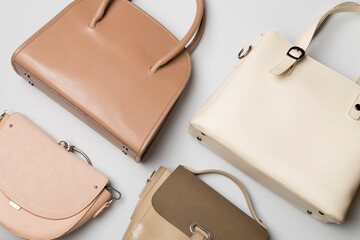 Many women's bags on a color background. Top view