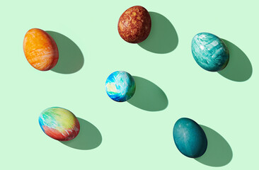 Pattern of easter eggs on green pastel background