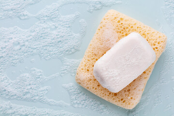 Soap bar and foam on white background, top view. Mockup for design