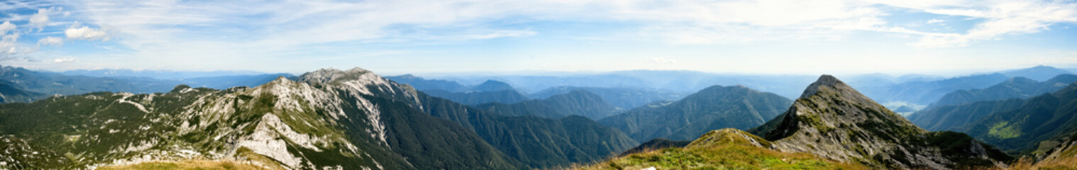 Rocky mountain peaks in the Julian Alps in Slovenia near the Vogel hill. Summer mountains and landscape over Lake Bohinj.