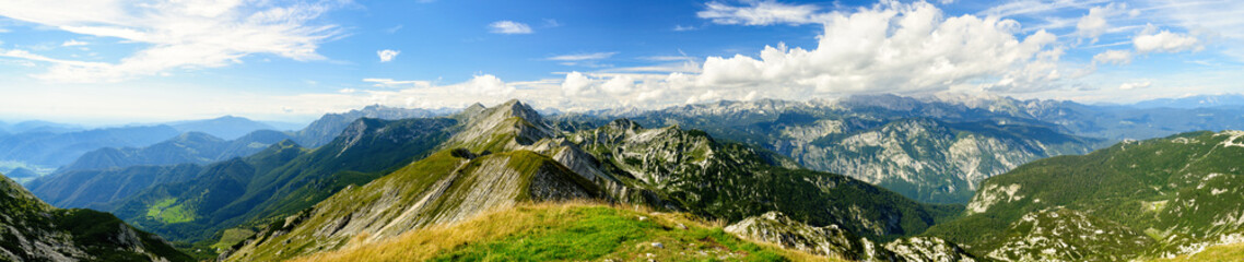 Rocky mountain peaks in the Julian Alps in Slovenia near the Vogel hill. Summer mountains and landscape over Lake Bohinj. - obrazy, fototapety, plakaty