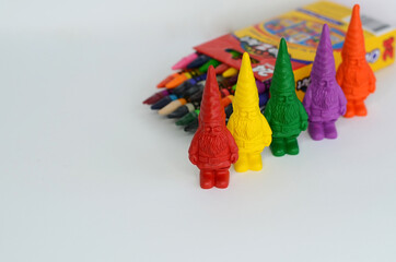 Multi-colored gnome-shaped wax crayons and wax crayons.