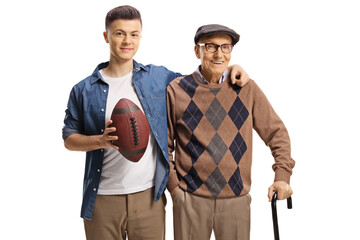 Young man holding a rugby ball and hugging an elderly man