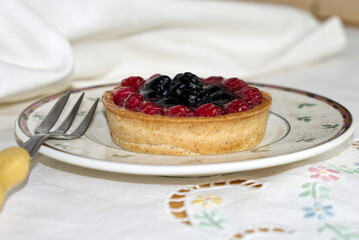 a delicious tart with berries and custard