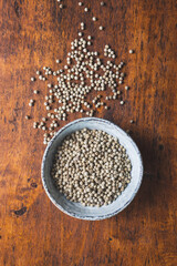 Whole pepper spice. White peppercorn grain in bowl