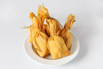 A GROUP OF 5 CHUCHITOS PLACED ON A WHITE PLACE IN A WHITE BACKGROUND