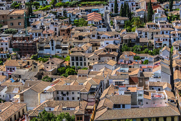 Fototapeta na wymiar Beautiful aerial view city of Granada in a daytime. Granada - capital city of province of Granada, located at foot of Sierra Nevada Mountains. Granada, Andalusia, Spain.