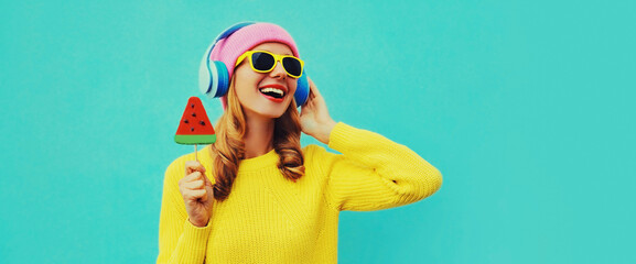 Summer fresh colorful portrait of happy laughing young woman in headphones listening to music with...