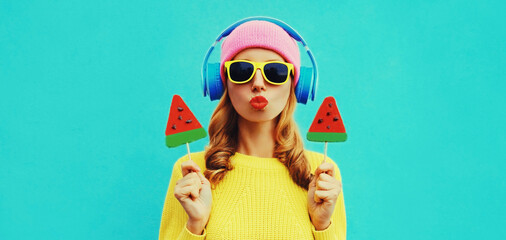 Summer fresh colorful portrait of happy young woman in headphones listening to music with fruit...