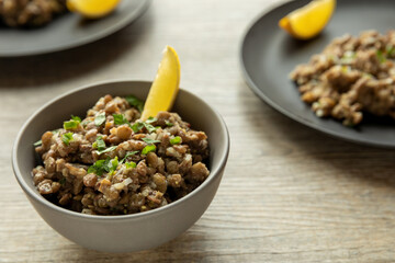 Lentil salad with homemade mustard and lemon juice wedge. Ethiopian cuisine. Azifa dish with...