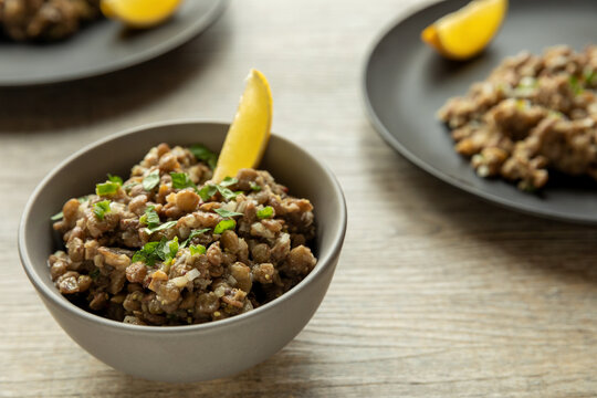 Lentil salad with homemade mustard and lemon juice wedge. Ethiopian cuisine. Azifa dish with senafich spice.