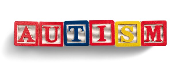 Autism above letter wood blocks spelling autism