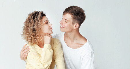 Portrait of a hugging couple on light background, st. Valentine's Day concept