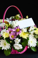 flowers in the basket with empty card