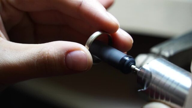 jeweler makes a ring. processing of jewelry. Jewelry repair shop. Master jeweler makes gold jewelry. Polishing the gold ring. Jewelry workshop. Gold ornament. Wedding ring