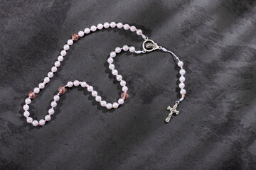 Fototapeta na wymiar Holy catholic rosary and a cross - Text space