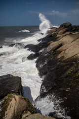 waves crashing on rocks in Punta Diablo in Uruguay 