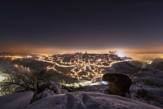 City at night under a blanket of snow and fog. Toledo