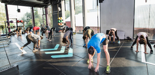 people working out during group fitness training at gym in Bangkok