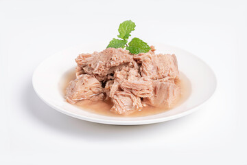 Chunk of canned tuna on white plate on white background.