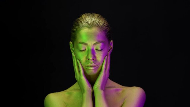 Woman Covered With Golden Body Paint Posing On Black Background