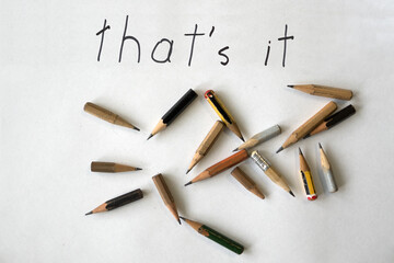 Ironic retirement farewell note 'that's it' with worn pencils on white background