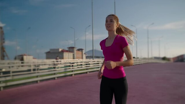 Urban sporty girl jogging around the city