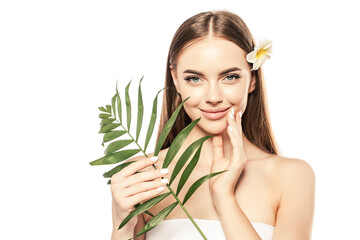 Naklejka premium Woman with beautiful skin face with tropical leaf in her hands. Girl with palm tree. Spa model.