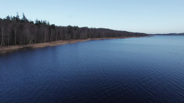 Birdseye View of  Skanderborg Lake and it's Shoreline, Denmark - Dolly In Shot 