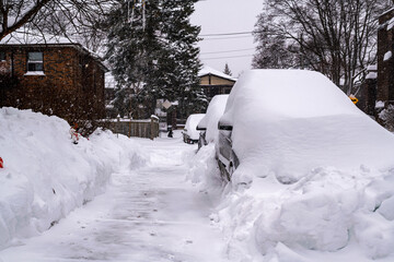  As a blizzard sweeps into a residential neighbourhood the streets fill with snow and residents start to shovel out their cars and sidewalks. Shot in Toronto’s Beaches neighbourhood in January.