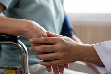 Doctor using hand to touch senior adult for give good emotional