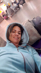 A young woman waiting her flight in the airport. Selfie