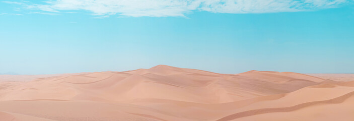 Scenic view of sand dunes on a bright sunny day with blue skies and orange sand