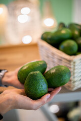 Smiling woman applying scrub peeling face mask massaging skin looking at mirror reflection bathroom