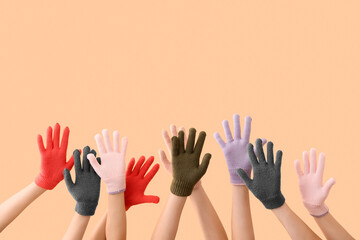 Obraz premium Women in warm gloves on beige background