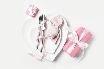 Stylish table setting and gifts for Valentine's Day on white background