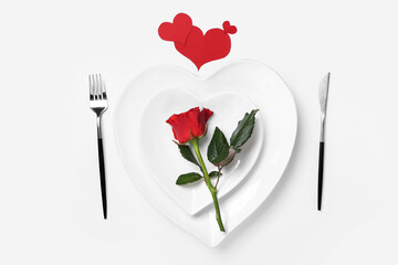 Stylish table setting and rose flower for Valentine's Day on white background